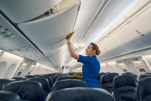woman standing in the aisle of a plane