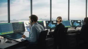 a man and a woman sitting at a desk with many computers